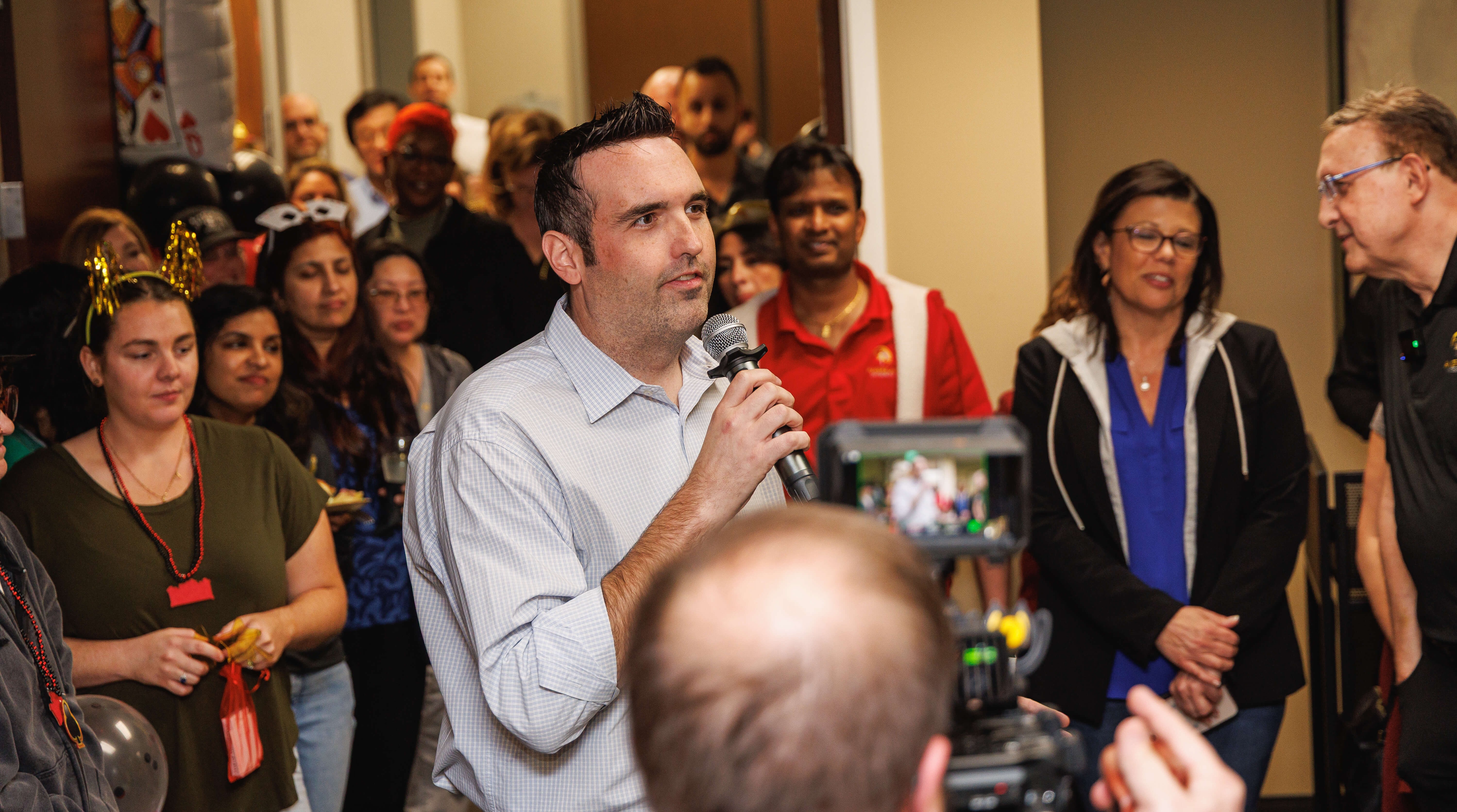 Jon Ritchie gives a speech in celebration of serving 300,000 policies as a team of 300 employees and reaching 30,000 LinkedIn followers.